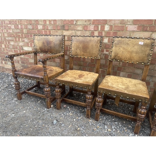 14 - A set of six oak framed dining chairs with tan brown seats and brass studs