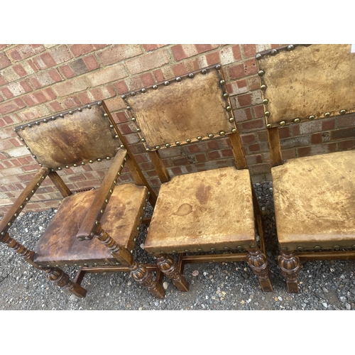 14 - A set of six oak framed dining chairs with tan brown seats and brass studs