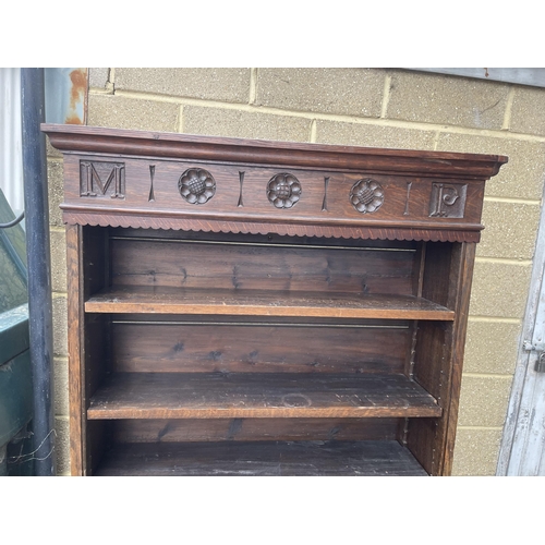 144 - A early 20th century oak open fronted bookcase with adjustable shelves and carved top 122x27x177