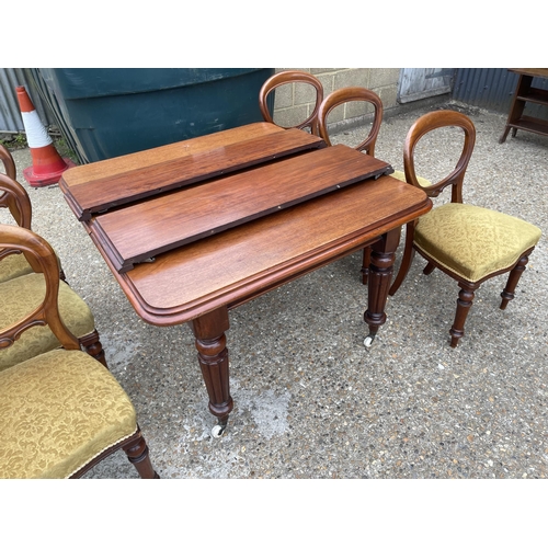 148 - A victorian mahogany extending dining table with two leaves 120x112 closed together with a set of si... 