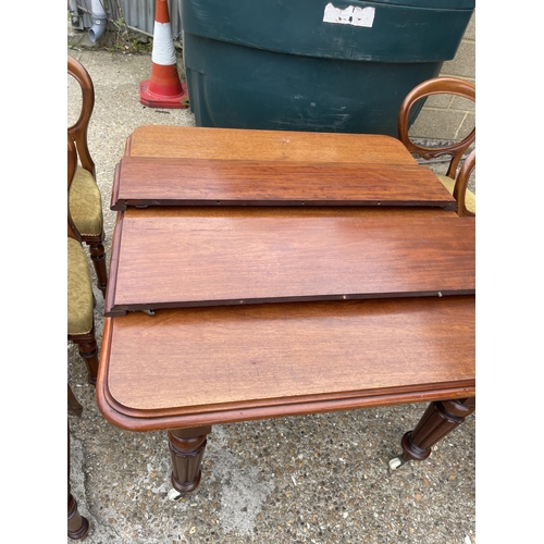 148 - A victorian mahogany extending dining table with two leaves 120x112 closed together with a set of si... 