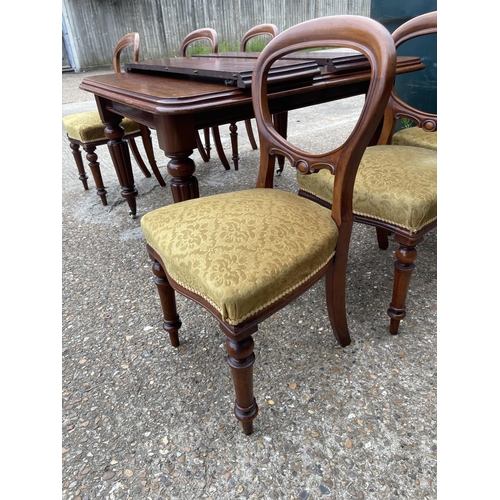 148 - A victorian mahogany extending dining table with two leaves 120x112 closed together with a set of si... 