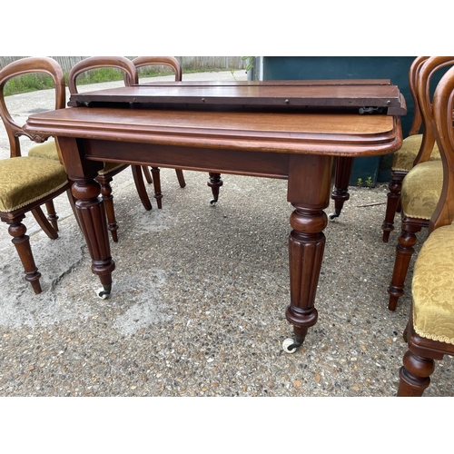 148 - A victorian mahogany extending dining table with two leaves 120x112 closed together with a set of si... 