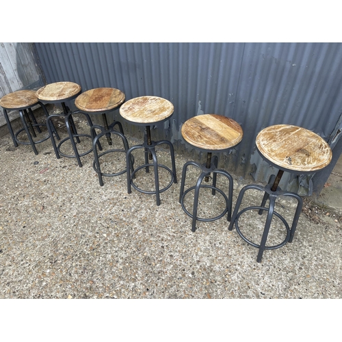 153 - A set of six industrial style swivel adjust stools