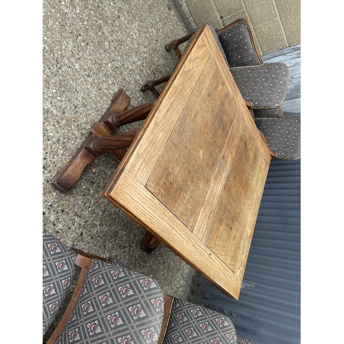 164 - An early 20th century oak drawer leaf dining table together with a se of 8 matching oak chairs with ... 