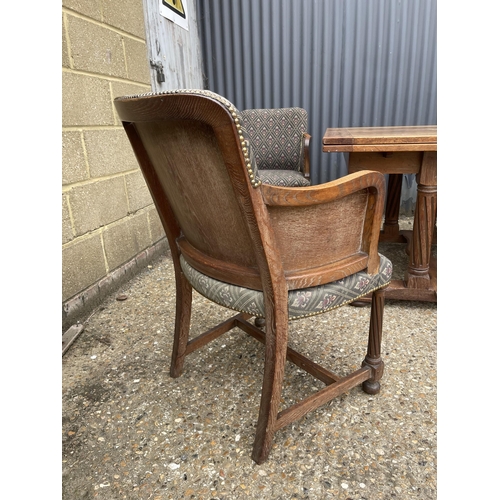 164 - An early 20th century oak drawer leaf dining table together with a se of 8 matching oak chairs with ... 