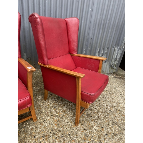 178 - A pair of red vinyl mid century wing chairs