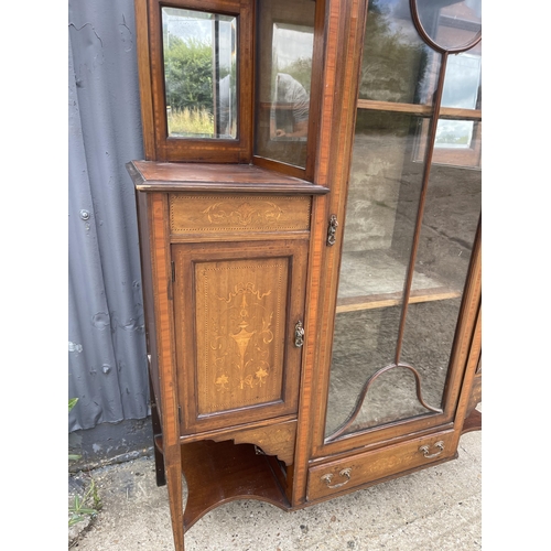 211 - An Edwardian mahogany cabinet with mirror back