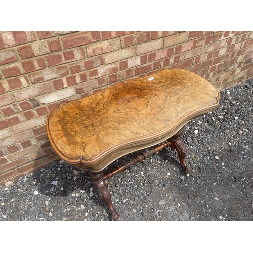 22 - A Victorian burr walnut card table with fold over top to reveal red baize playing surface