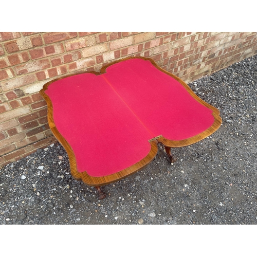 22 - A Victorian burr walnut card table with fold over top to reveal red baize playing surface