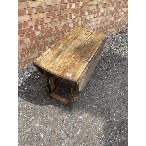 24 - An oak barley twist gate-leg table