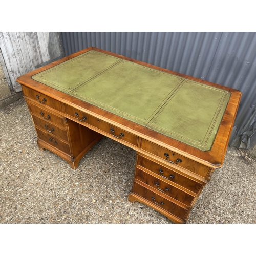 246 - A reproduction yew wood twin pedestal partners desk with drawers to the front and cupboards to the r... 