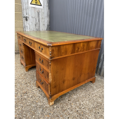 246 - A reproduction yew wood twin pedestal partners desk with drawers to the front and cupboards to the r... 