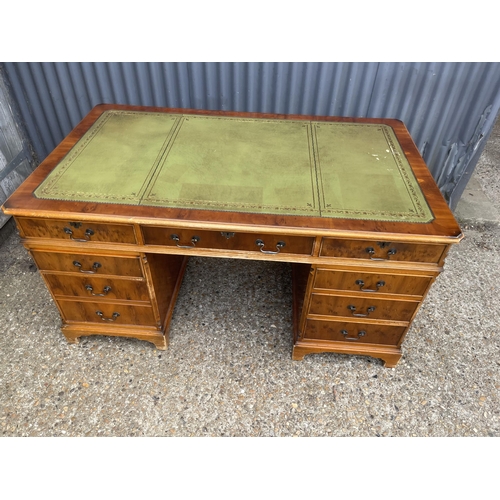 247 - A reproduction yew wood twin pedestal partners desk with drawers to the front and cupboards to the r... 