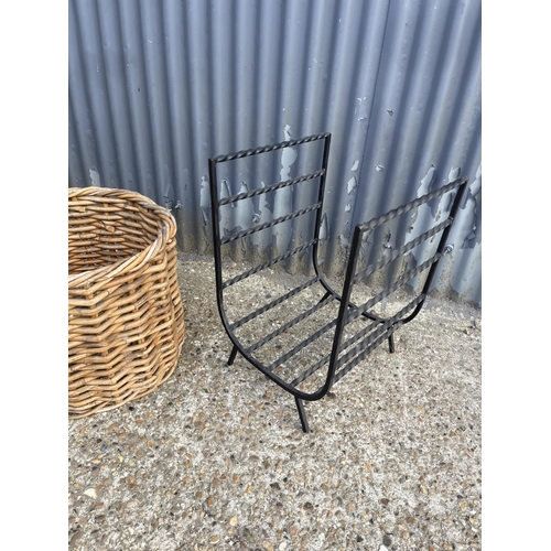 255 - A pair of iron fireside log racks together with a wicker log basket