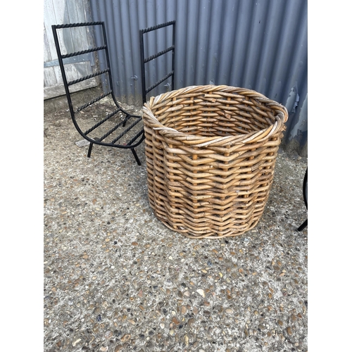 255 - A pair of iron fireside log racks together with a wicker log basket