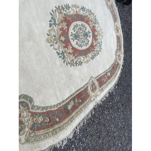 27 - A large oval pattern rug 310x200