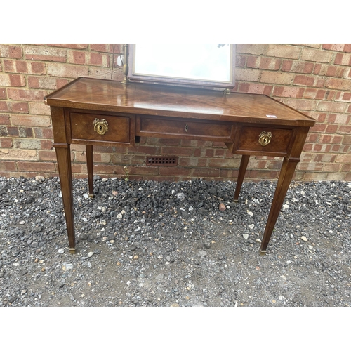 28 - A continental mahogany three drawer dressing table with brass lamps either side of a swing mirror