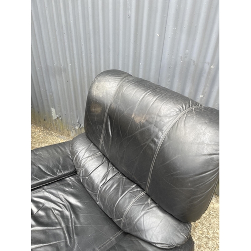 296 - A pair of mid 20th century teak framed armchairs with black leather seats