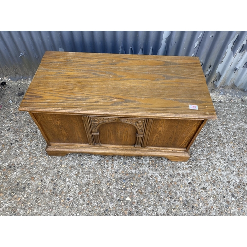 318 - An oak blanket box with carved front