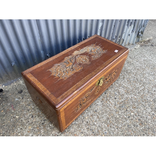 319 - An oriental carved camphor wood blanket box