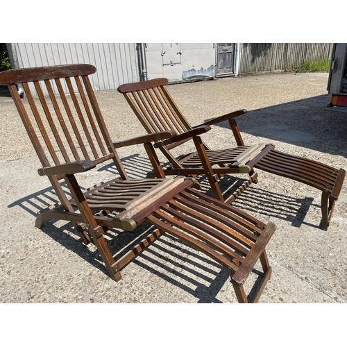 325 - A pair of hardwood steamer style garden lounger chairs with cushions