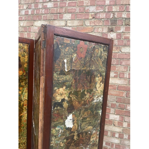 33 - A mahogany framed four section folding screen with Victorian paper scrap panels to front and red and... 