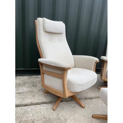 331 - A pair of Ercol swivel and recline armchairs with one footstool