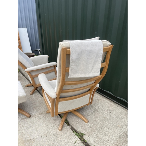 331 - A pair of Ercol swivel and recline armchairs with one footstool