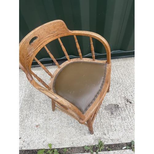 335 - An oak bow back desk chair