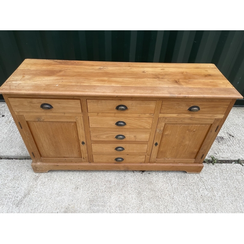 337 - A farmhouse style pine sideboard fitted with seven drawers and two cupboards 160x 50x90