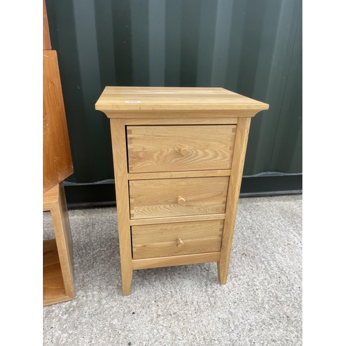 339 - A modern light oak three drawer bedside together with three modern cube storage units