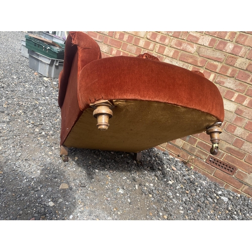 37 - A deep seated red upholstered armchair