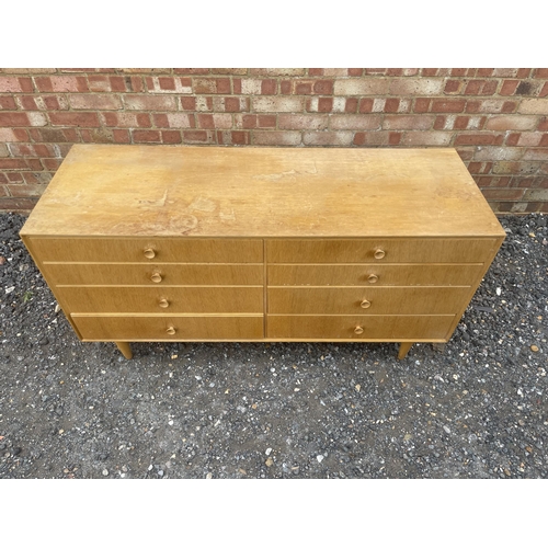 39 - A mid century light oak chest of 8 drawers 130x46 x 68