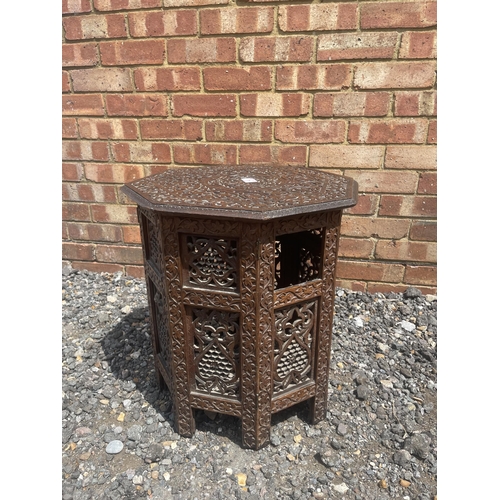 4 - A carved hexagonal Moorish occasional table 45 diameter x 50 high