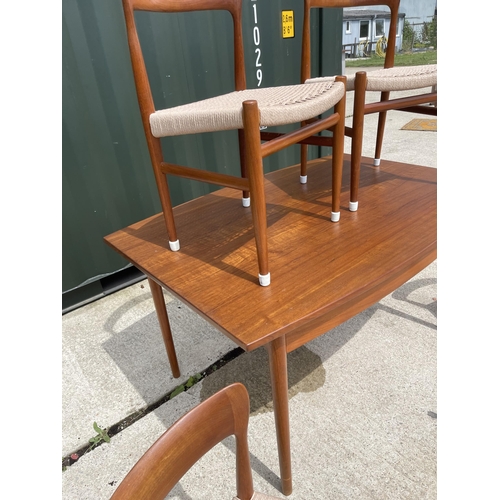 59 - Danish Teak draw leaf dining table together with a set of four Danish Teak dining chairs with string... 