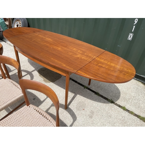 59 - Danish Teak draw leaf dining table together with a set of four Danish Teak dining chairs with string... 