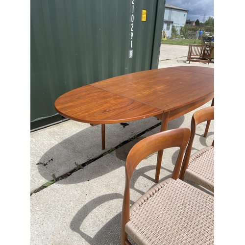 59 - Danish Teak draw leaf dining table together with a set of four Danish Teak dining chairs with string... 