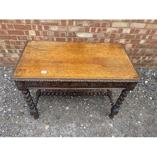 7 - A carved oak centre table with single drawer and barley twist legs  105x60x77 cms