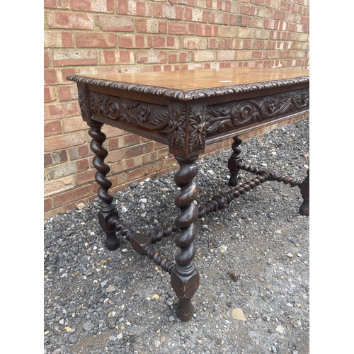 7 - A carved oak centre table with single drawer and barley twist legs  105x60x77 cms