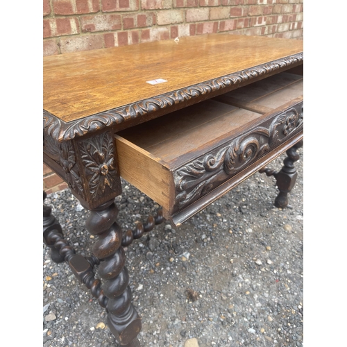 7 - A carved oak centre table with single drawer and barley twist legs  105x60x77 cms