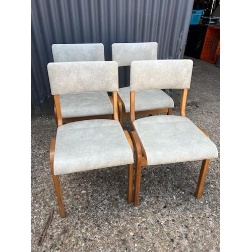 74 - A set of four retro bent ply stacking chairs with vinyl seats