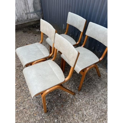 74 - A set of four retro bent ply stacking chairs with vinyl seats