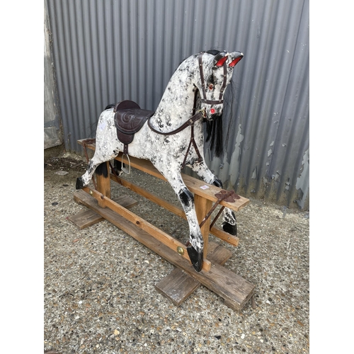 82 - A white painted swing rocking horse on pine base 120 long 102 tall