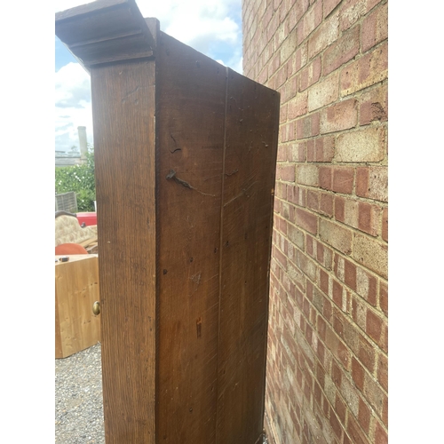 9 - An antique oak two section country house corner cupboard fitted with shelves 100cm wide