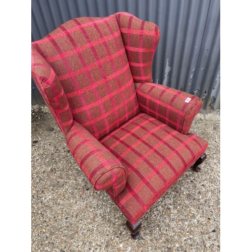 95 - A red chequered pattern wing back armchair