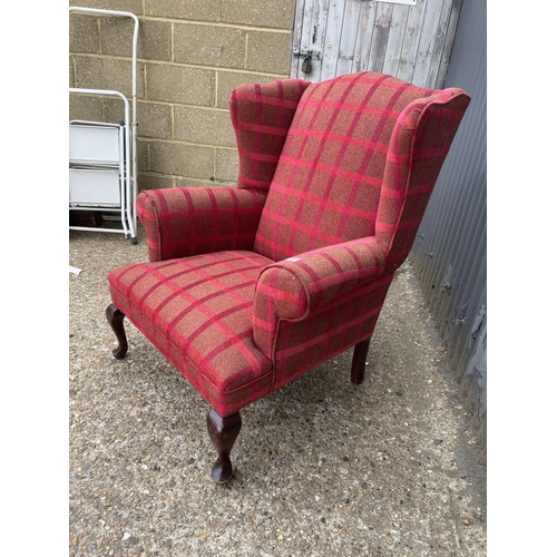 95 - A red chequered pattern wing back armchair