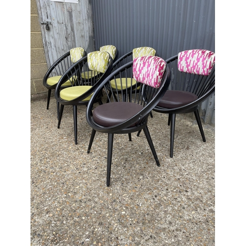 97 - A set of six modern designer chairs by VITRA, tub shaped with stick backs and pink / green upholster... 