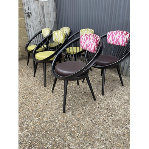 97 - A set of six modern designer chairs by VITRA, tub shaped with stick backs and pink / green upholster... 