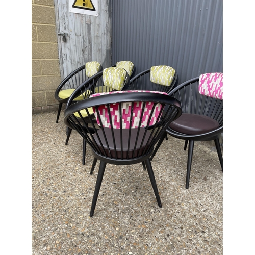 97 - A set of six modern designer chairs by VITRA, tub shaped with stick backs and pink / green upholster... 